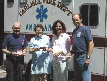 Fire Department Staff With Women in Front of Ambulance