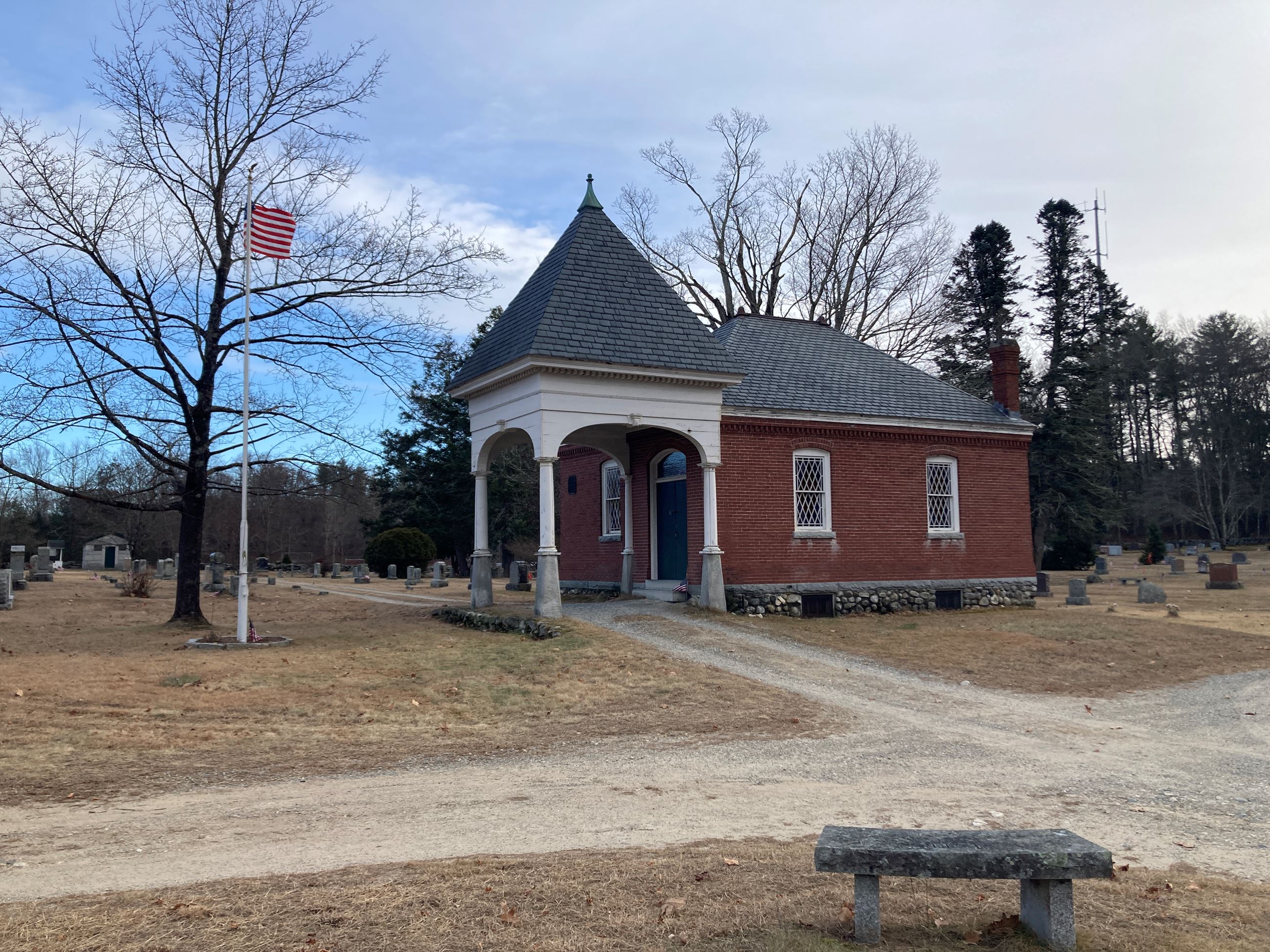 Wilson Chapel on a sunny day. Red brick building with decorative windows and a gray roof.